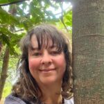 head shot of a women under a tree